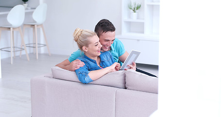 Image showing couple relaxing at  home with tablet computers