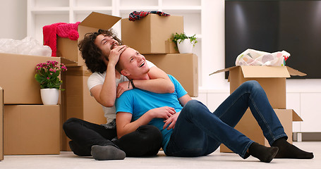 Image showing young  gay couple moving  in new house