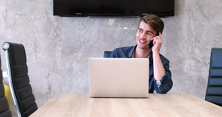 Image showing businessman working using a laptop in startup office