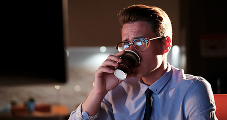 Image showing Tired businessman working late