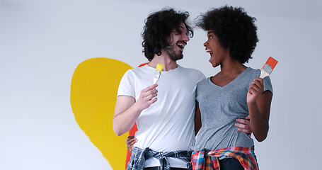 Image showing couple with painted heart on wall