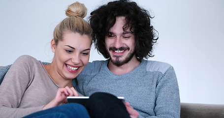 Image showing couple relaxing at  home with tablet computers