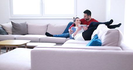 Image showing couple relaxing at  home with tablet computers