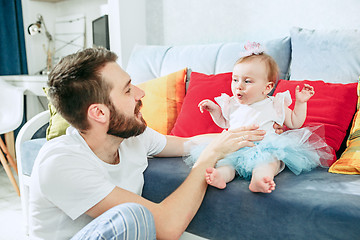 Image showing Proud father holding his baby daughter at home