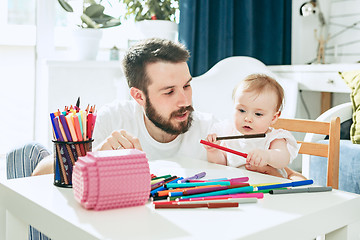 Image showing father and his baby daughter at home