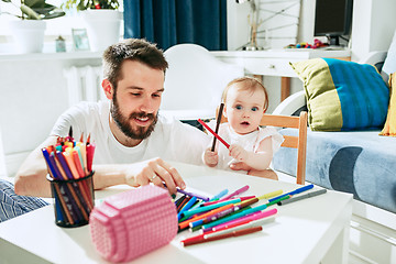 Image showing father and his baby daughter at home