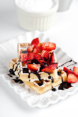 Image showing Belgium waffers with sugar powder, strawberries and chocolate on