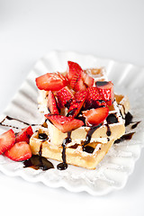 Image showing Belgium waffers with sugar powder, strawberries and chocolate on