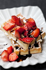 Image showing Belgium waffers with sugar powder, strawberries and chocolate on