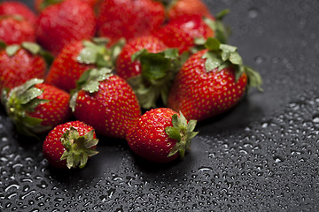 Image showing Fresh ripe strawberry with water drops closeup.