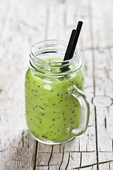 Image showing Green smoothie with kiwi, apple, lime and linen seeds. Healthy f