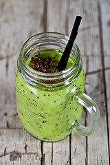 Image showing Green smoothie with kiwi, apple, lime and linen seeds. Healthy f