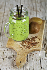 Image showing Green smoothie with kiwi, apple, lemon and linen seeds. Healthy 