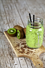 Image showing Green smoothie with kiwi, apple, lemon and linen seeds. Healthy 