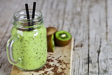 Image showing Green smoothie with kiwi, apple, lemon and linen seeds. Healthy 
