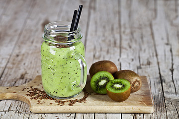 Image showing Green smoothie with kiwi, apple, lemon and linen seeds. Healthy 