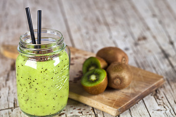 Image showing Green smoothie with kiwi, apple, lemon and linen seeds. Healthy 