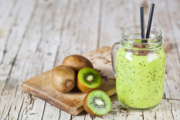 Image showing Green smoothie with kiwi, apple, lemon and linen seeds. Healthy 