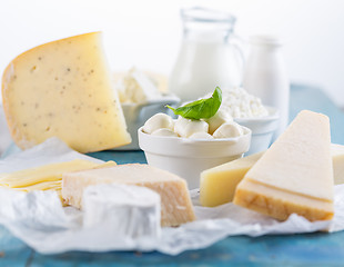 Image showing Different types of dairy products on wooden background