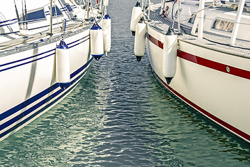 Image showing Blue and red motorboats in the marina