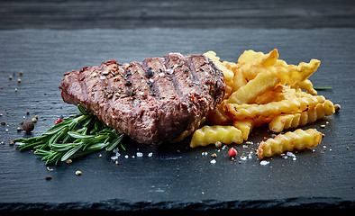 Image showing grilled beef fillet steak and fried potatoes