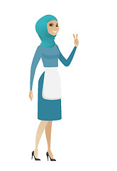 Image showing Young muslim cleaner showing victory gesture.