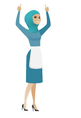 Image showing Young muslim cleaner standing with raised arms up.