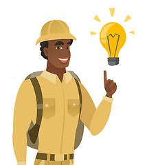 Image showing African-american traveler pointing at light bulb.