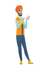 Image showing Young hindu builder holding a mobile phone.