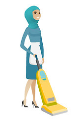 Image showing Muslim chambermaid cleaning floor with a vacuum.