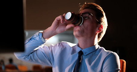 Image showing Tired businessman working late