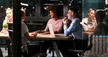 Image showing Multiethnic startup business team in night office