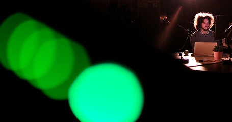 Image showing man working on computer in dark office