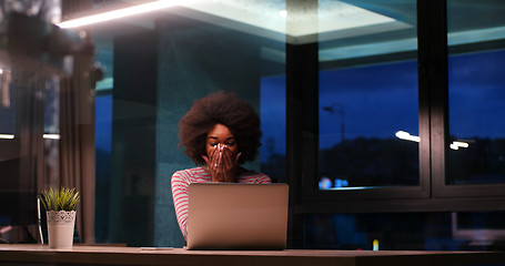 Image showing black businesswoman using a laptop in night startup office