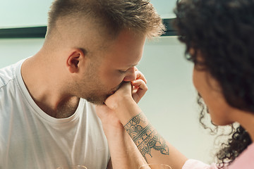 Image showing She said him yes. Closeup of young man kissing his wife hand while making marriage proposal outdoors.