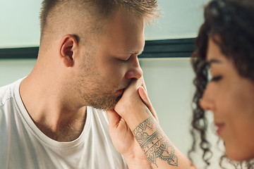 Image showing She said him yes. Closeup of young man kissing his wife hand while making marriage proposal outdoors.