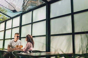 Image showing Cheerful couple in cafe having a good time.