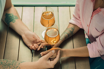 Image showing She said him yes. Closeup of young man kissing his wife hand while making marriage proposal outdoors.