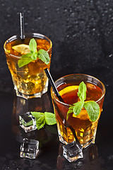 Image showing Two glasses with cold traditional iced tea with lemon, mint leav