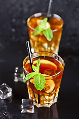 Image showing Two glasses with cold traditional iced tea with lemon, mint leav