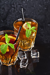 Image showing Two glasses with cold traditional iced tea with lemon, mint leav
