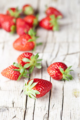 Image showing Fresh red strawberries on rustic wooden background. 