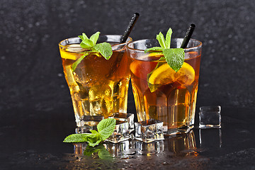 Image showing Two glasses with cold traditional iced tea with lemon, mint leav