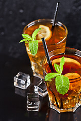 Image showing Two glasses with cold traditional iced tea with lemon, mint leav