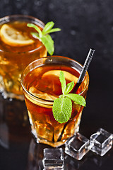 Image showing Two glasses with cold traditional iced tea with lemon, mint leav