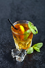 Image showing Traditional fresh iced tea with lemon, mint leaves and ice cubes