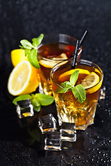 Image showing Two glasses with cold traditional iced tea with lemon, mint leav