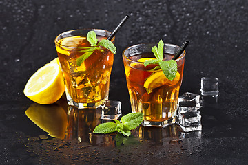 Image showing Two glasses with cold traditional iced tea with lemon, mint leav