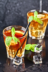 Image showing Two glasses with cold traditional iced tea with lemon, mint leav