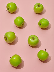Image showing green apples on pink background